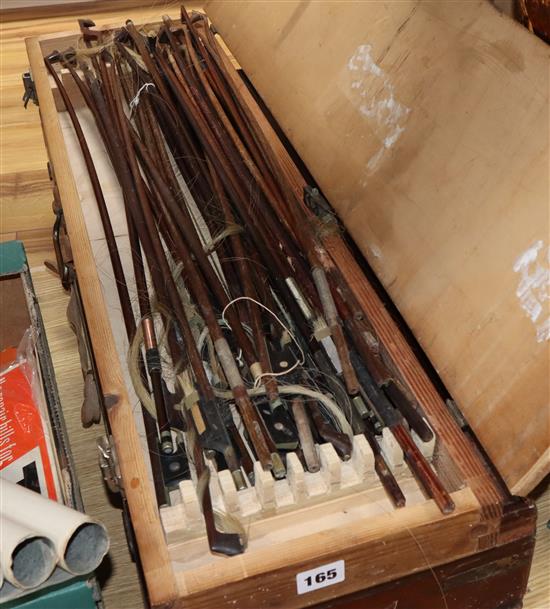 Two violins in a mahogany box and a collection of violin bows